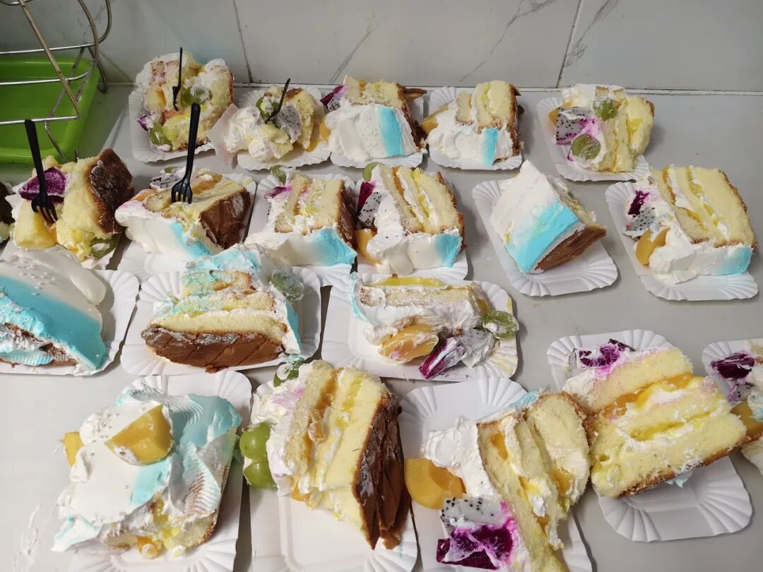 Slices of birthday cake portioned out for the team