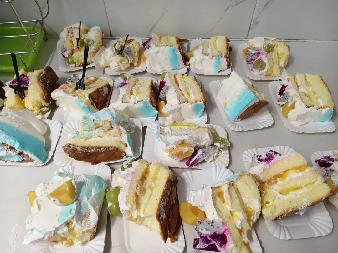 Slices of birthday cake portioned out for the team