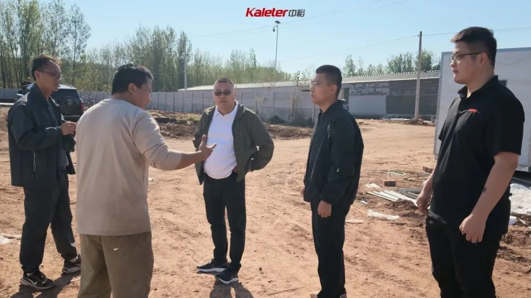 The General Manager talking with the project team outside the breeder houses