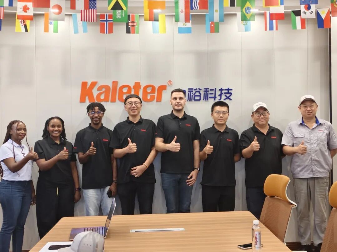 An international team at Kaleter's Zhucheng facility, gathered under flags from their home countries