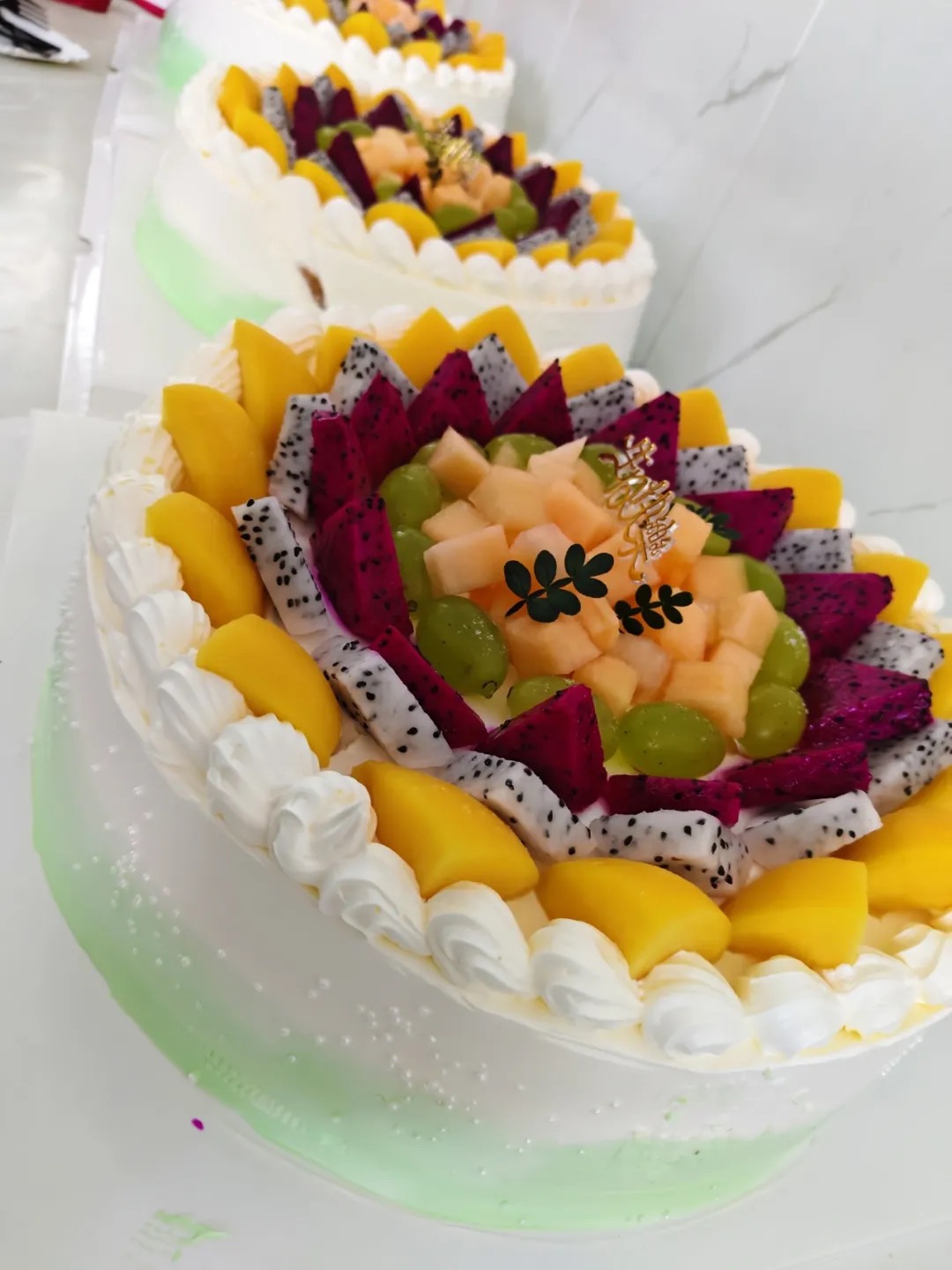 Birthday cakes lined up and decorated for Kaleter's July celebration