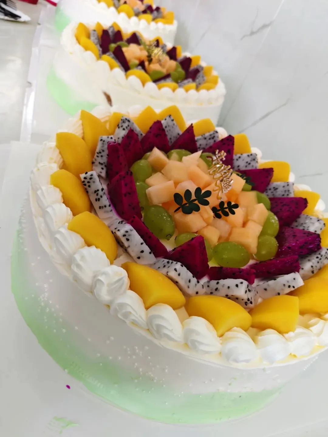 Birthday cakes lined up and decorated for Kaleter's July celebration