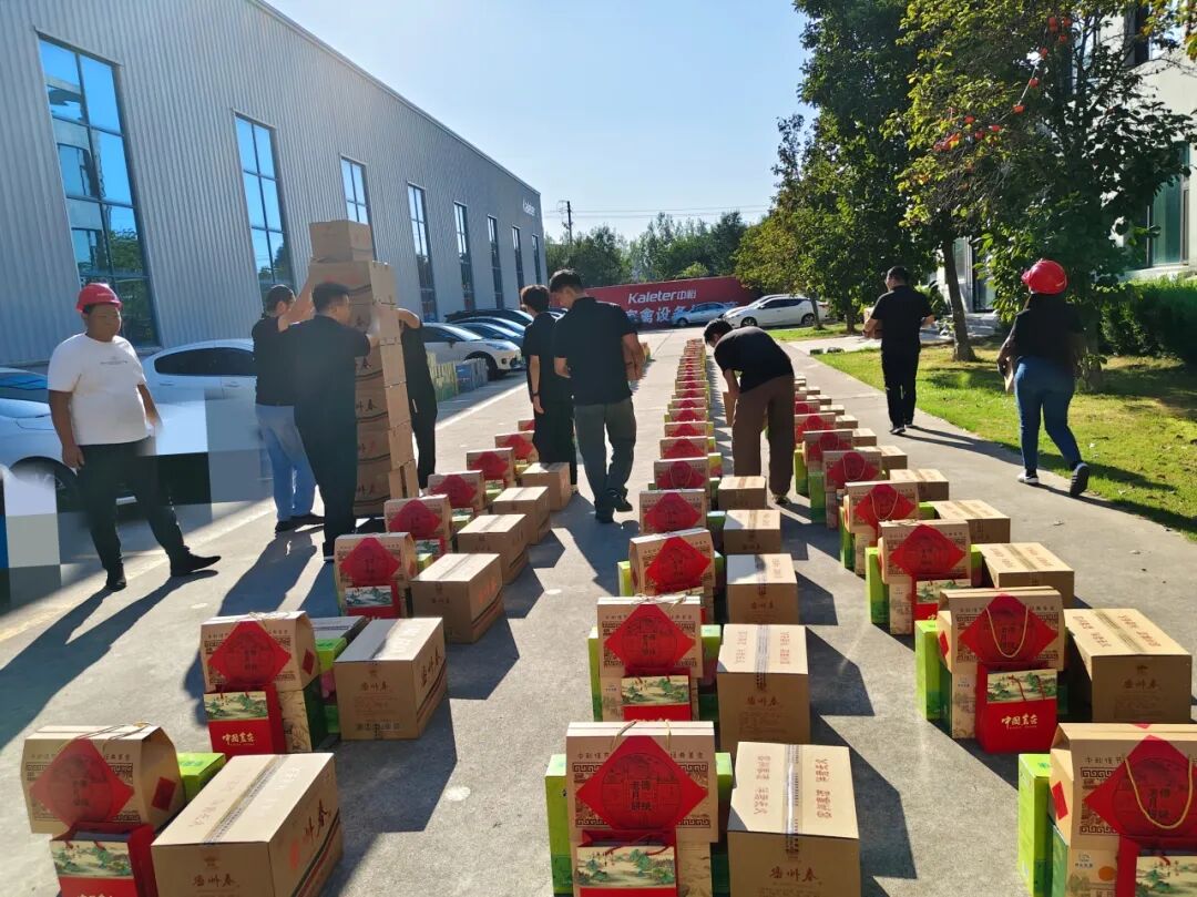 Employees sorting rows of Mid-Autumn Festival gift boxes outside the Kaleter office building