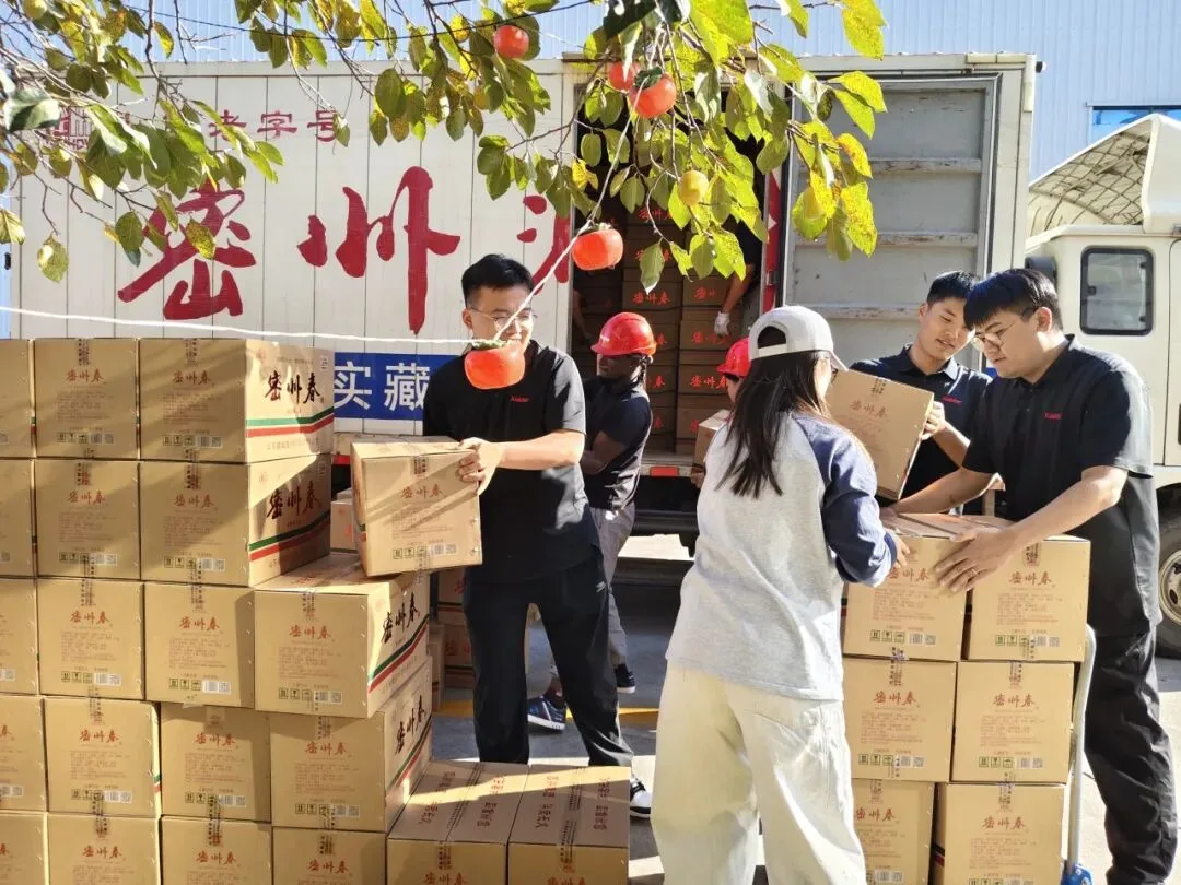 Colleagues unloading gift boxes from a delivery truck