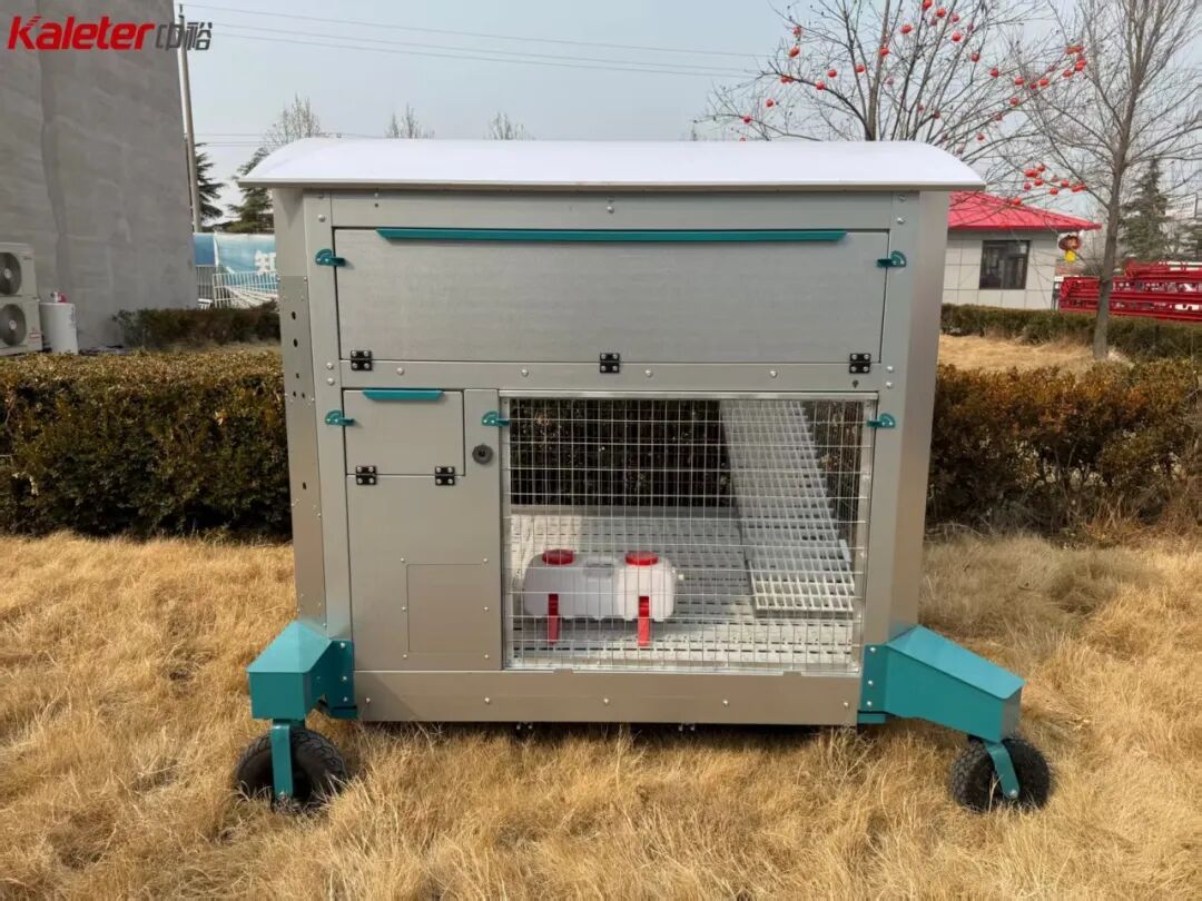 Kaleter family mobile chicken house on wheels, standing on grass with the run door open
