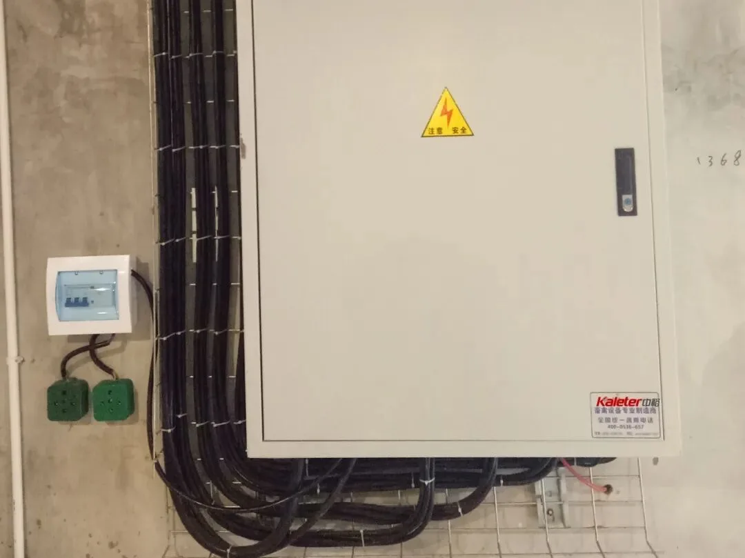 Wall-mounted distribution cabinet with cable dropping into the tray below