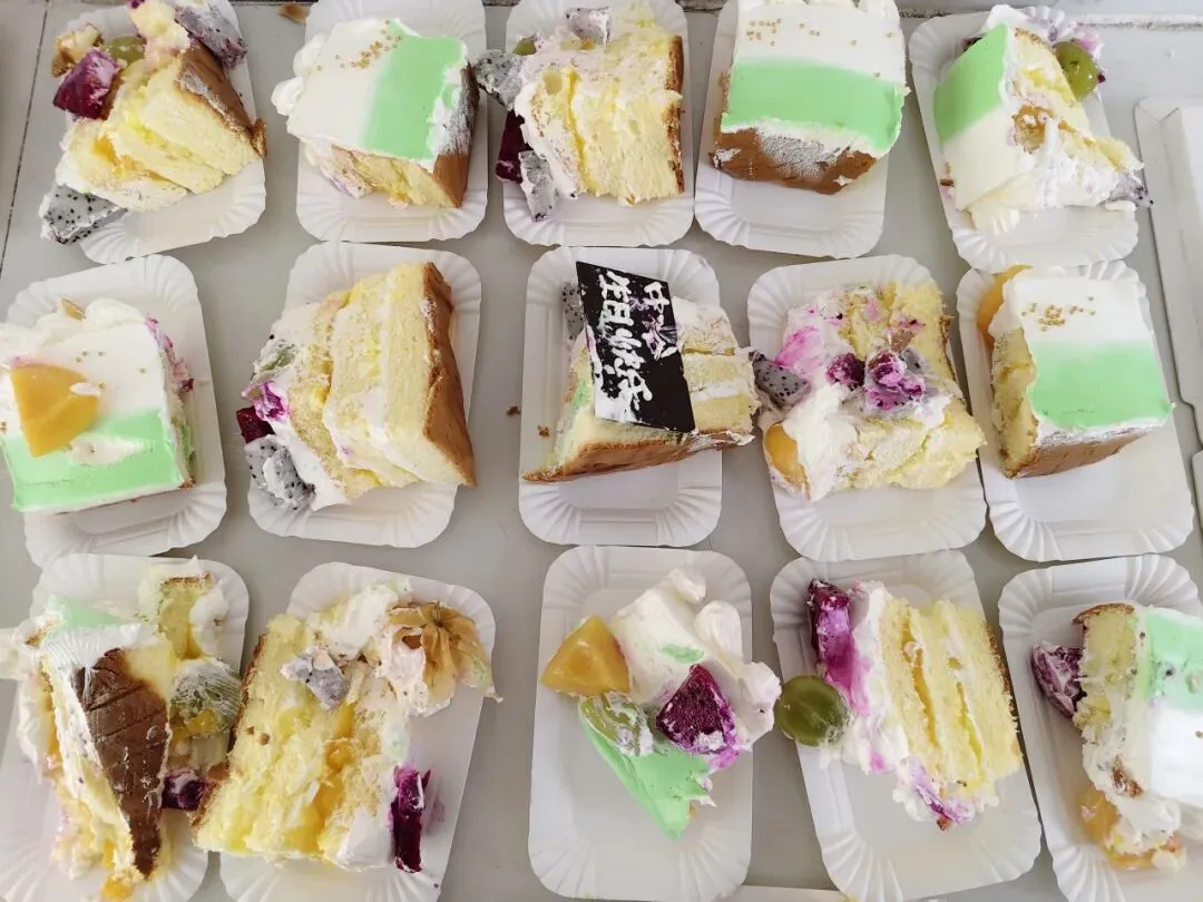 Slices of birthday cake portioned out for the team