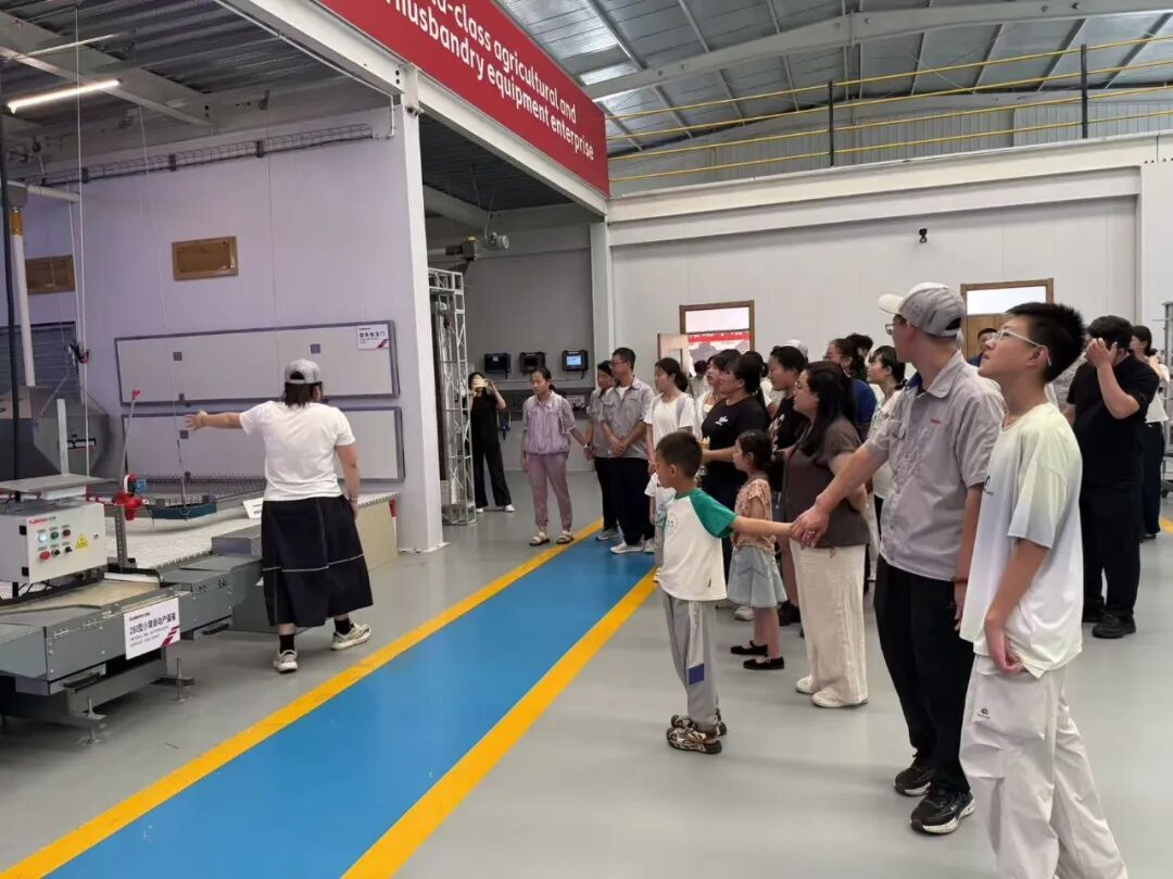 Employees and their families on a guided tour of the Kaleter production area
