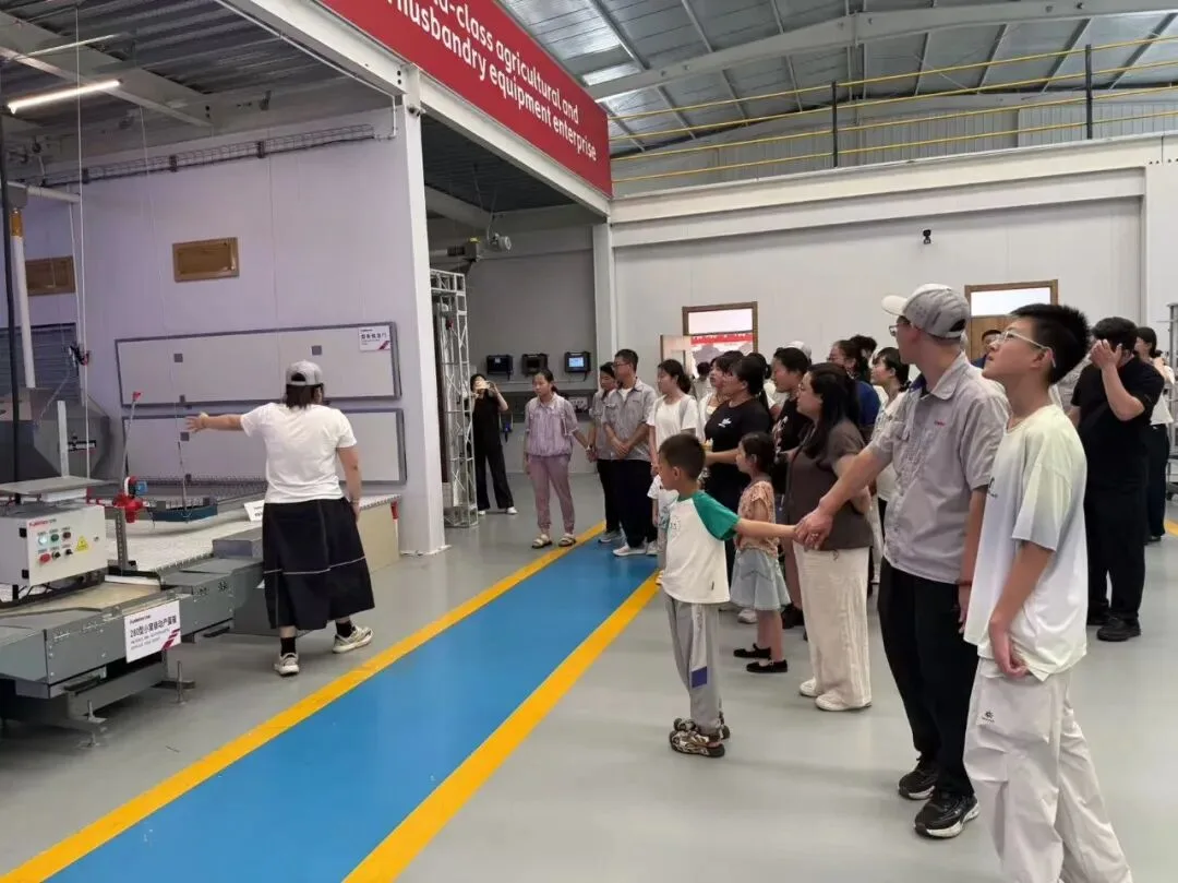 Employees and their families on a guided tour of the Kaleter production area
