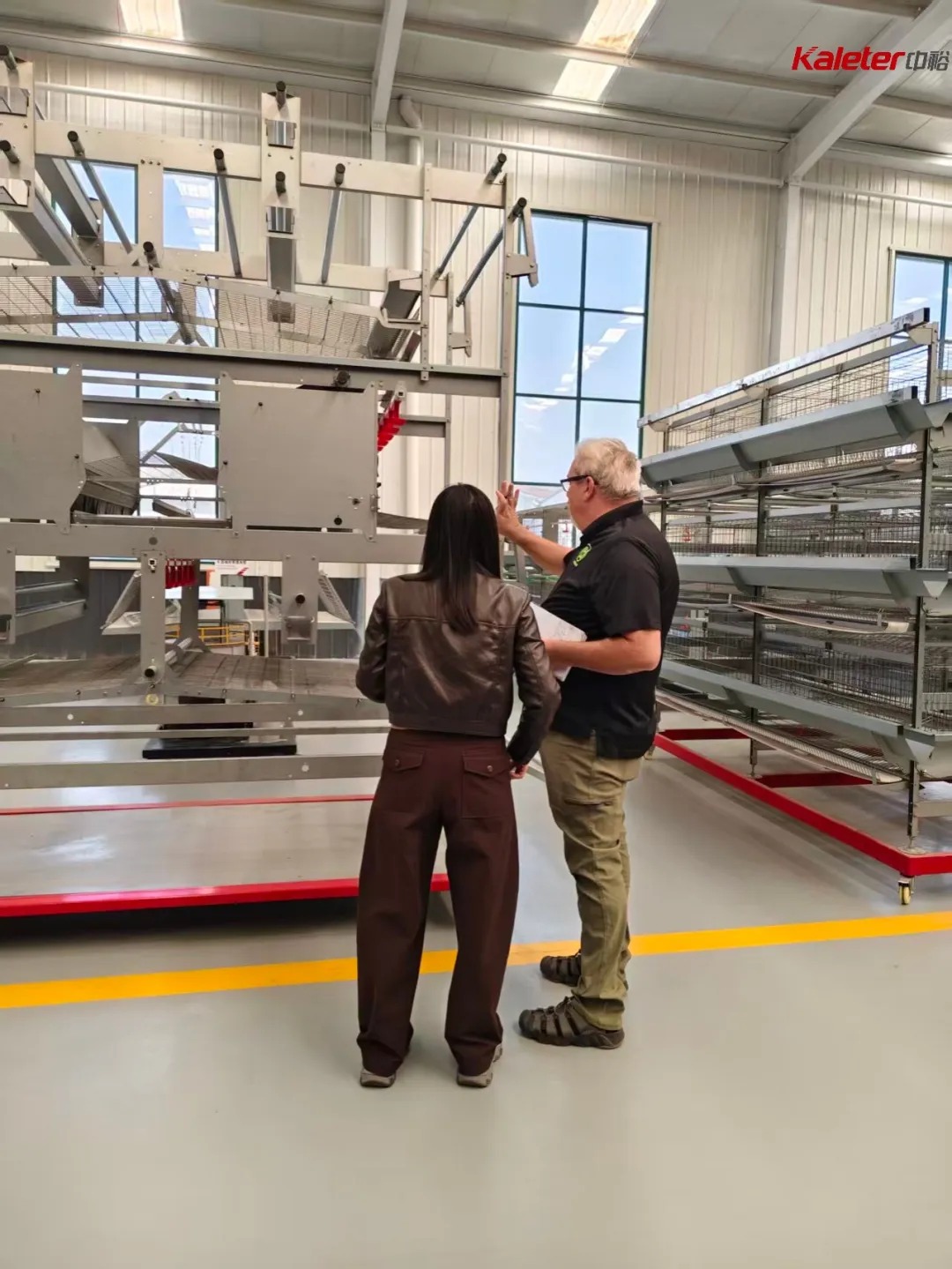 CloverLeaf auditor and Kaleter staff reviewing cage-free equipment inside the production facility