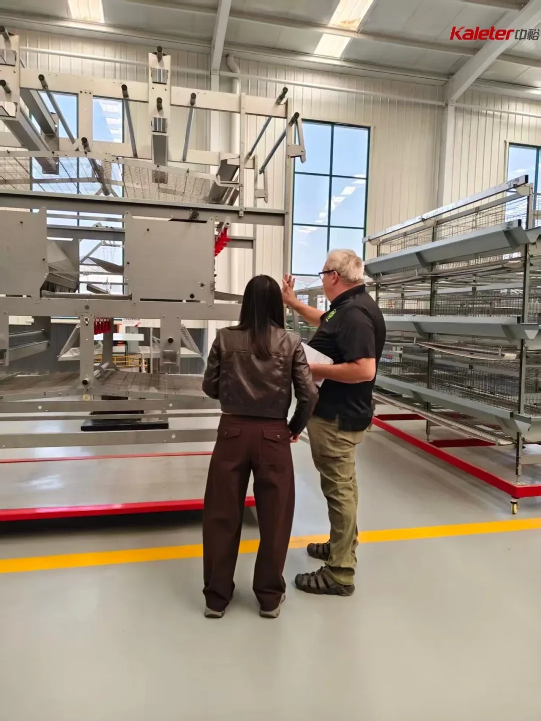 CloverLeaf auditor and Kaleter staff reviewing cage-free equipment inside the production facility