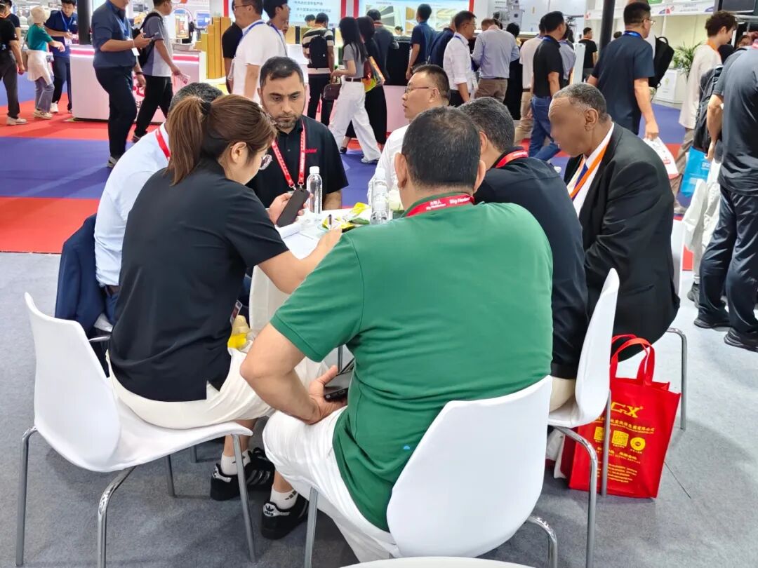 Customers meeting with Kaleter staff around a table at the exhibition stand