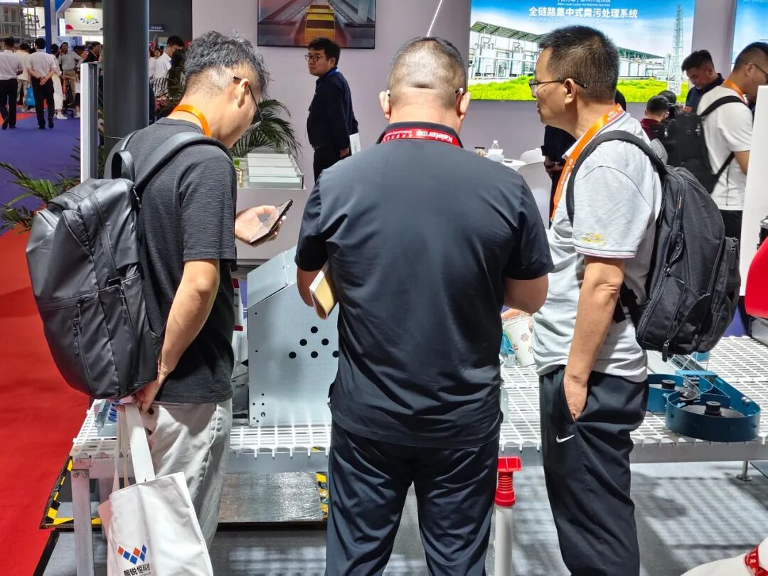 Visitors looking at manure handling equipment on the Kaleter stand