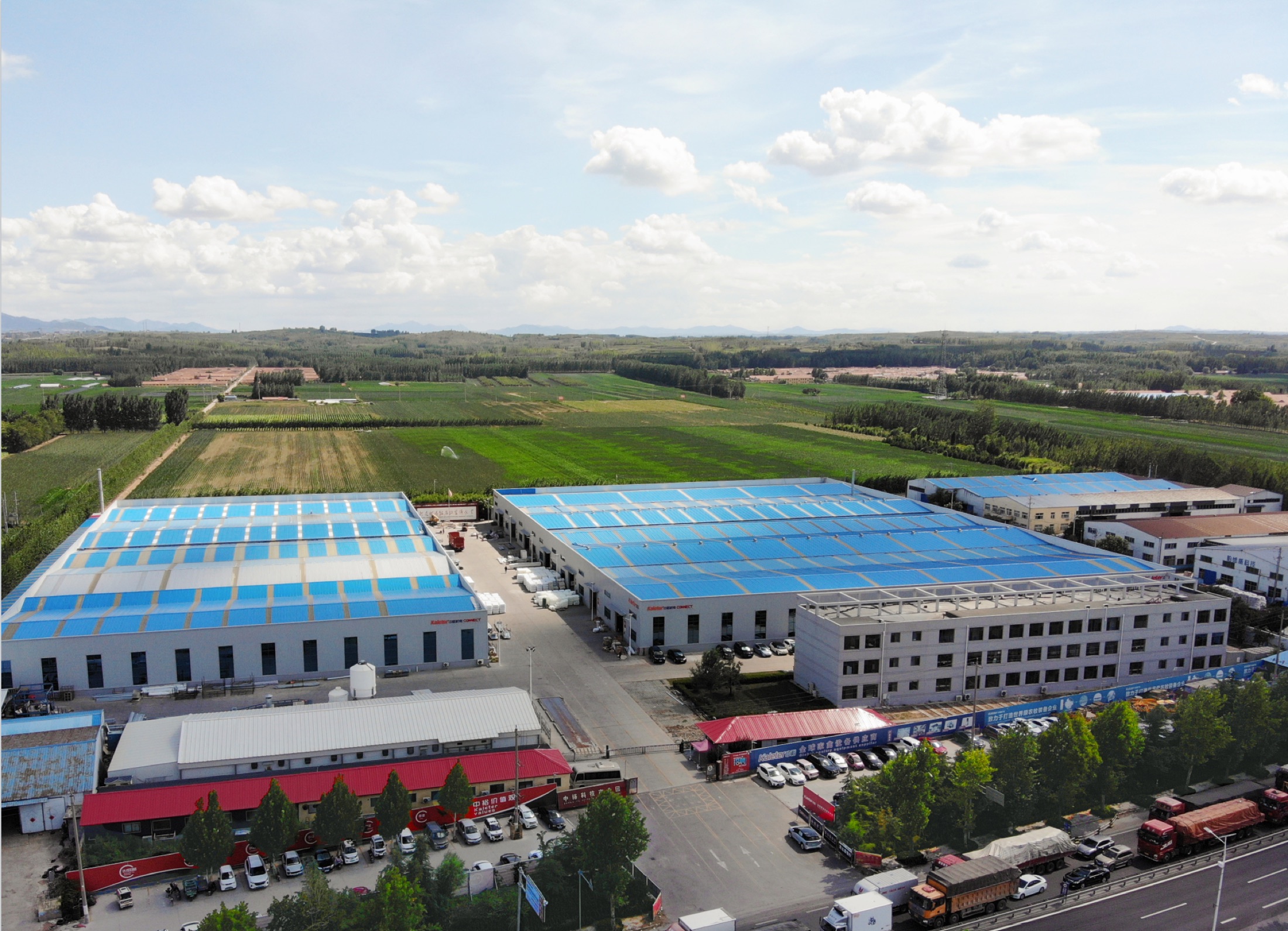 Aerial view of the Kaleter manufacturing plant in Zhucheng, Shandong, with farmland behind it
